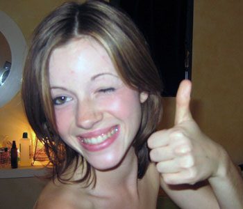 Cute coed giving thumbs-up.